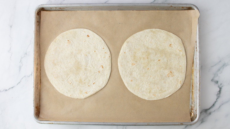 two tortillas on baking sheet