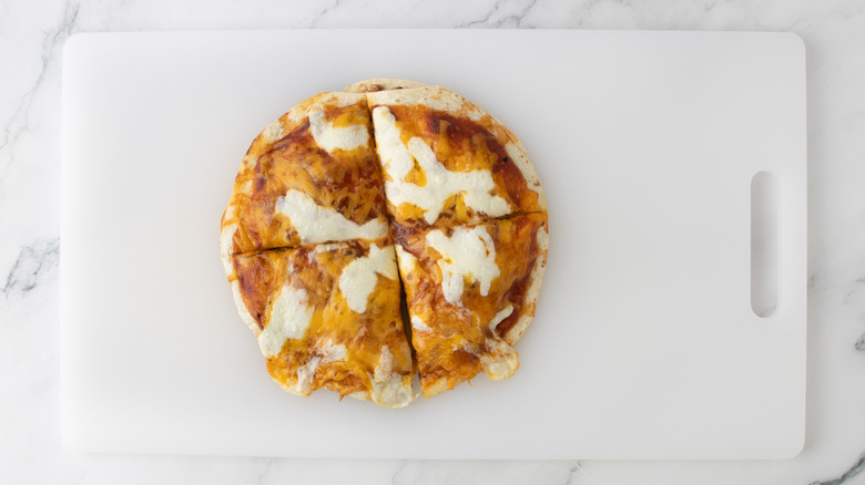 baked Mexican pizza cut in four