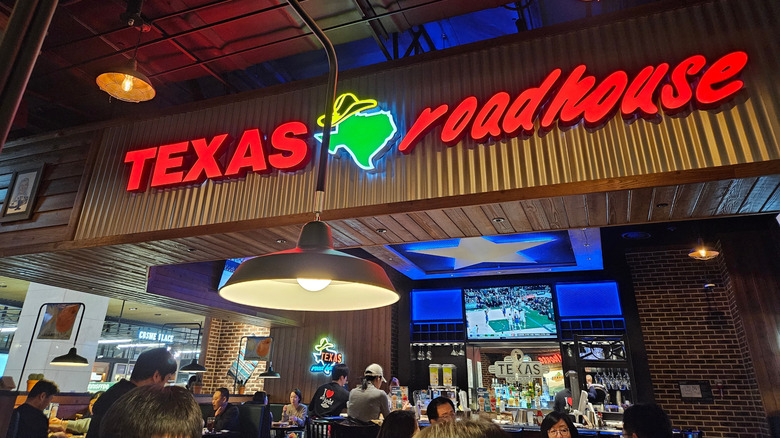 Interior shot of a Texas Roadhouse featuring the restaurant's neon sign