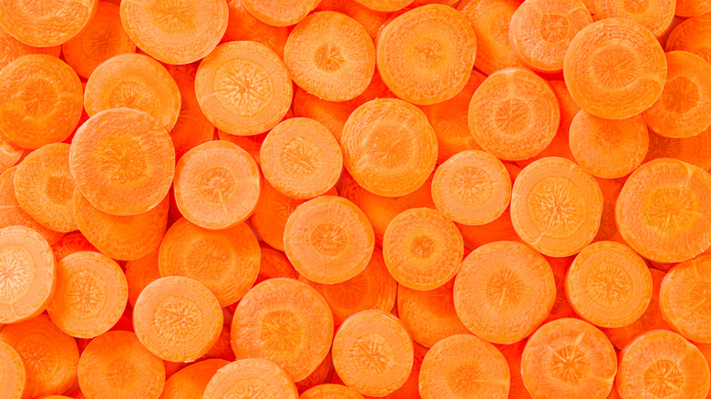 Carrot slices arrangement in a row composition full frame vegetables background