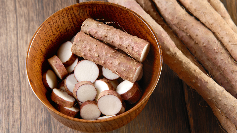 A bowl of sliced yam on a wooden surface