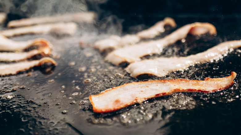 bacon frying on a pan