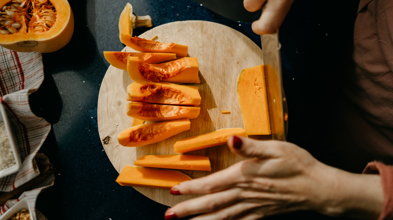 Person chopping butternut squash
