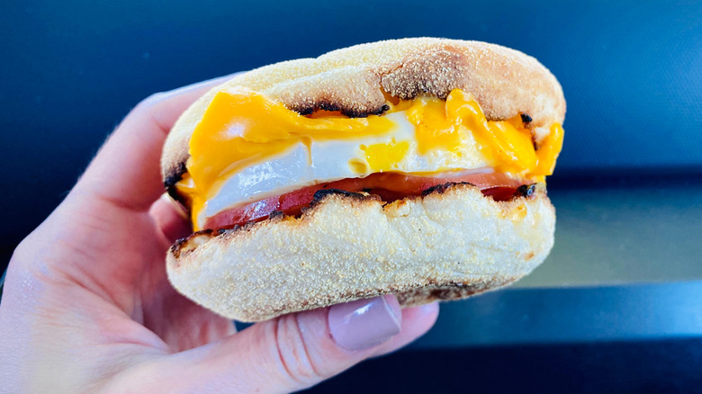 Hand holding an egg McMuffin
