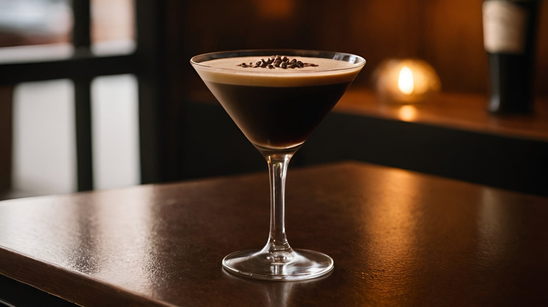 An espresso martini sitting on a brown wooden table