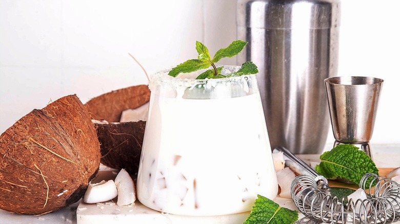 Coconut margarita on the rocks with fresh mint leaves