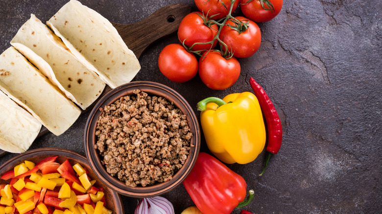 ingredients to make tacos on a cutting board