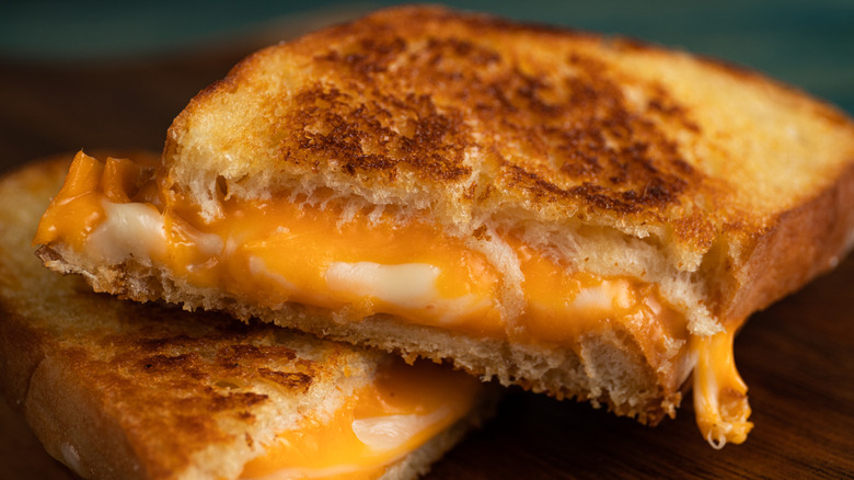 grilled cheese on a wooden cutting board