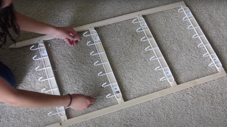 woman making hanging rack on the floor