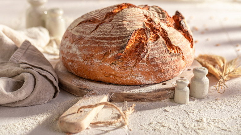 rustic round bread loaf on a wooden cutting board