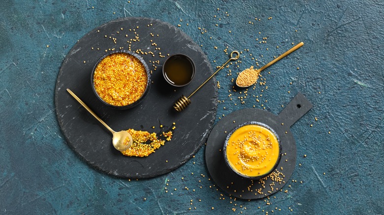 A bowl of honey and mustard on a gray background
