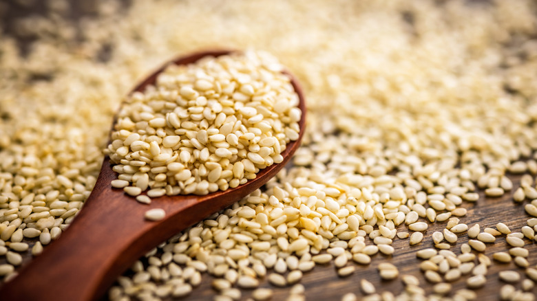 roasted sesame seeds on a wooden spoon