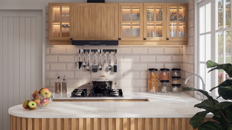 Small kitchen area with bowl of apples on a counter