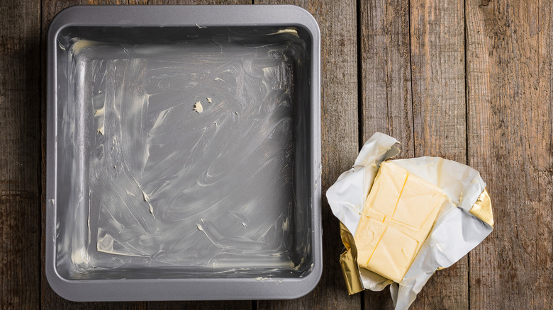 Metal baking tray with butter