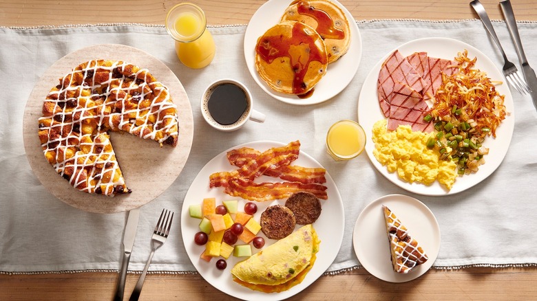 Overhead view of table with plates full of Golden Corral breakfast foods