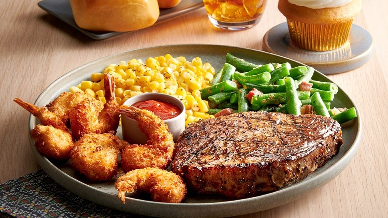 Plate of fried shrimp, steak, and veggies form Golden Corral