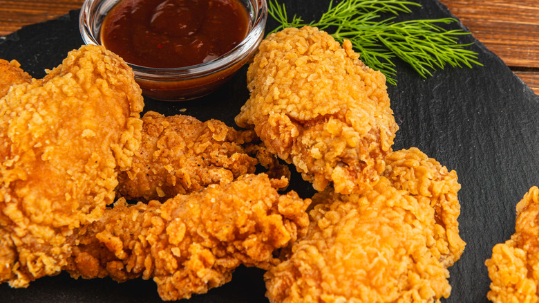 Chicken tenders are served with barbecue sauce