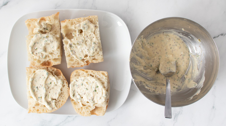 bread rolls with a creamy white spread on a white plate
