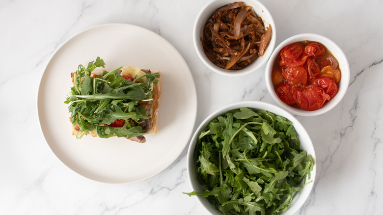 bread roll with lettuce on a white plate