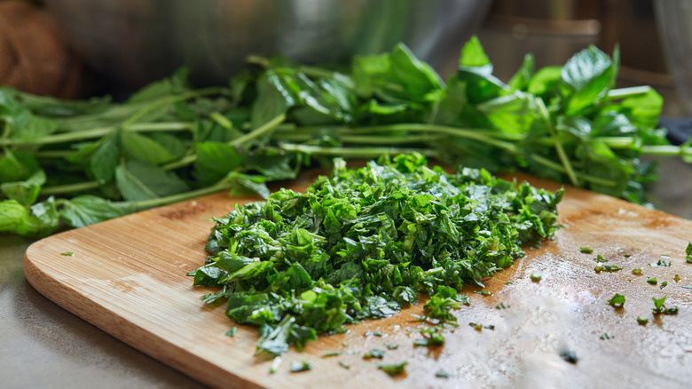 Chopped basil on a cutting board.