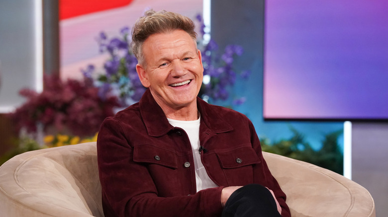 Gordon Ramsay sitting in a chair and smiling