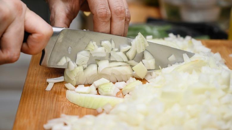 chopping onions with a sharp chef's knife