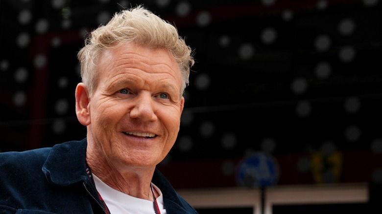 a smiling gordon ramsay attending a public event