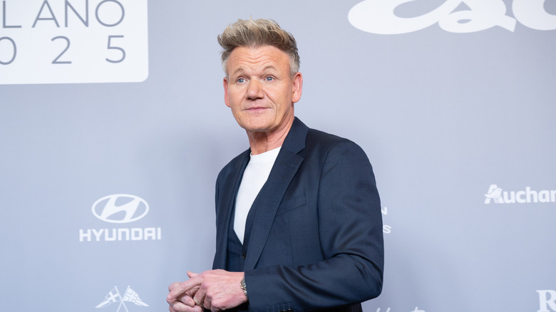 Celebrity chef Gordon Ramsay attending Esquire's "Men Of The Year" Awards at Real Casino de Madrid in Spain. He wears a dark blue suit with matching vest and a white undershirt