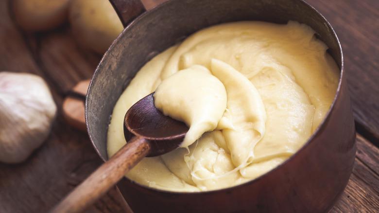 Creamy pommes aligot in a copper pot.