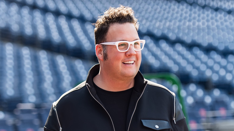 chef graham elliot smiling on baseball field