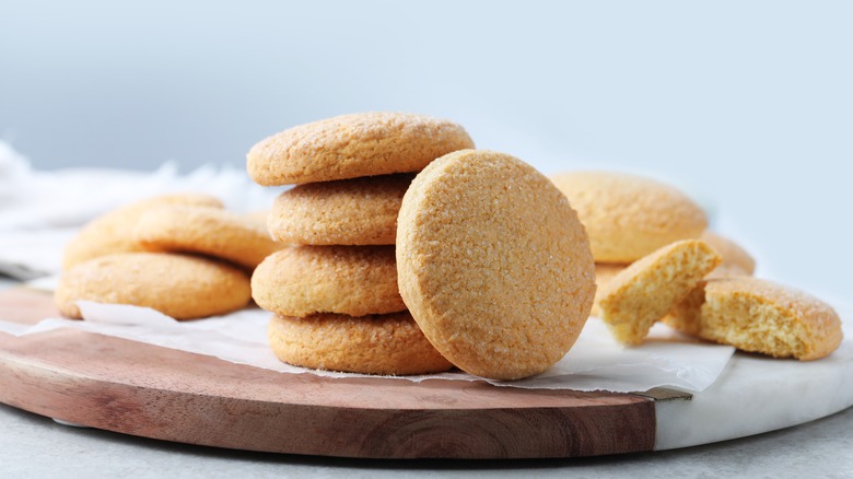 sugar cookies piled on a board