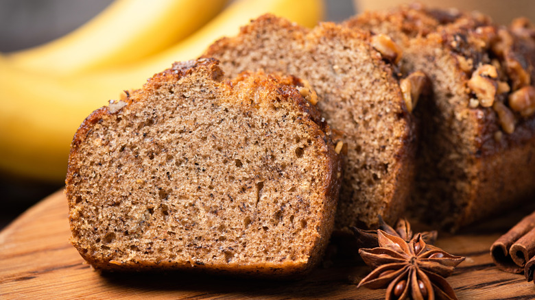 Banana bread with walnuts and cinnamon cut into slices. Slice of banana bread, closeup view
