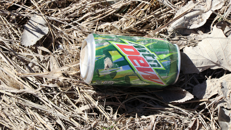 Empty Mountain Dew can thrown on the ground