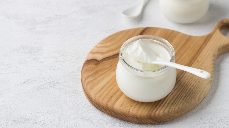 Greek yogurt on wooden board