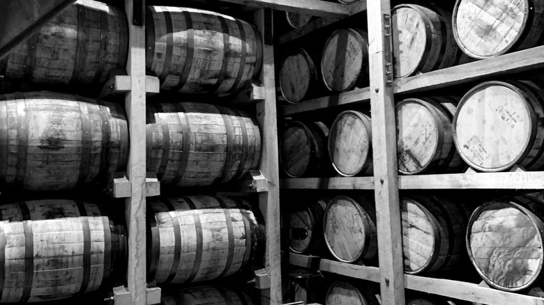 Jack Daniels whiskey barrels in the lower levels of a barrel house.