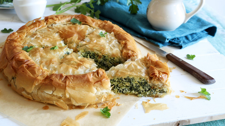 Traditional Greek cuisine. Spanakopita, savory pie. Homemade Greek phyllo dough pie filled with spinach and feta cheese.