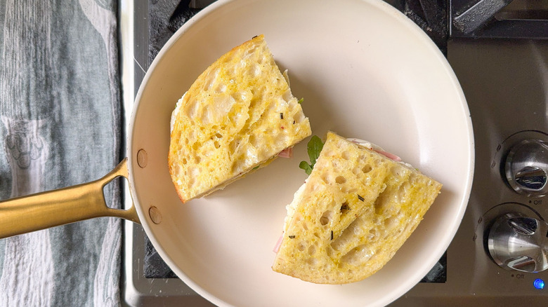 Italian focaccia sandwiches in skillet on stovetop