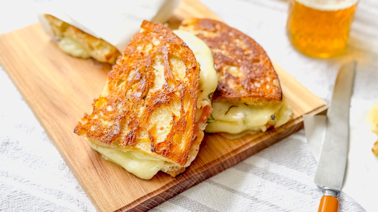 Grilled Italian picnic sandwiches stacked on cutting board