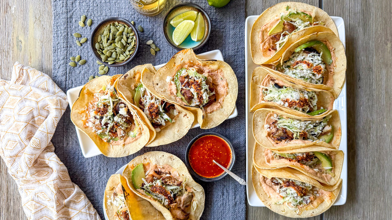 Grilled mushroom tacos with salsa macha crema on serving platter and plate