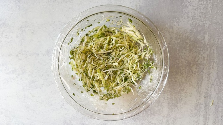 Slaw in plastic-covered glass bowl