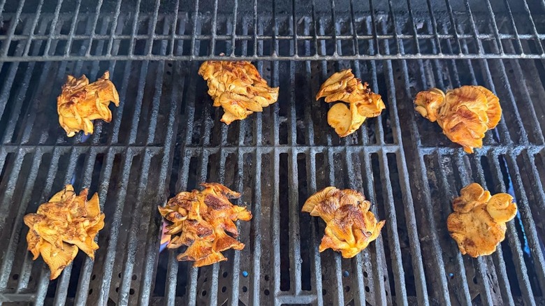 Marinated oyster mushroom clusters on grill