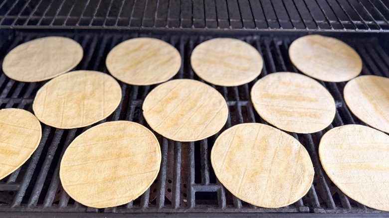 Corn tortillas on large grill