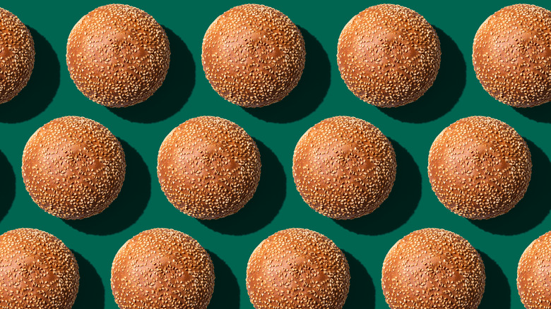 Rows of burger buns on a green background