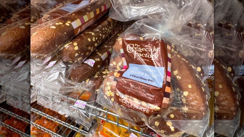 A few variations of packaged Cheesecake Factory brown bread at a grocery store