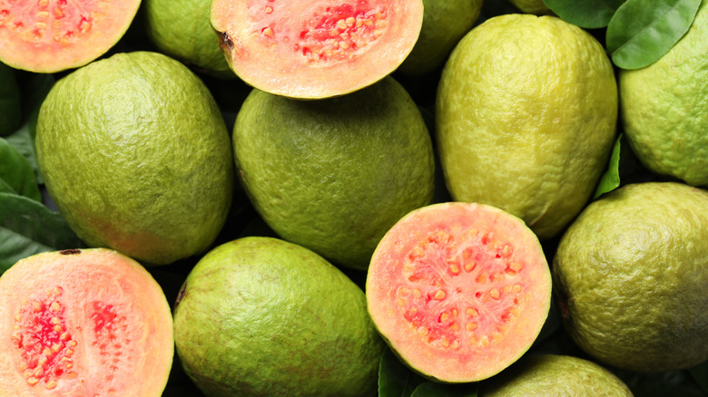 Whole and halved guava fruits