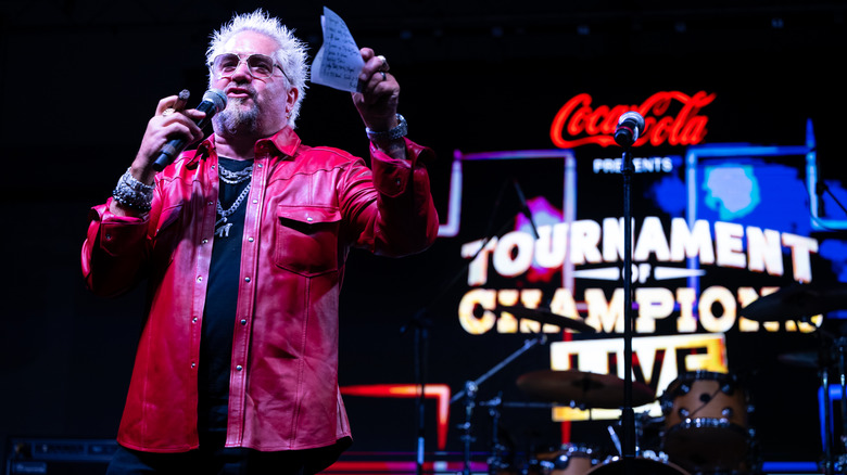 Guy Fieri onstage for his live episode of Tournament of Champions