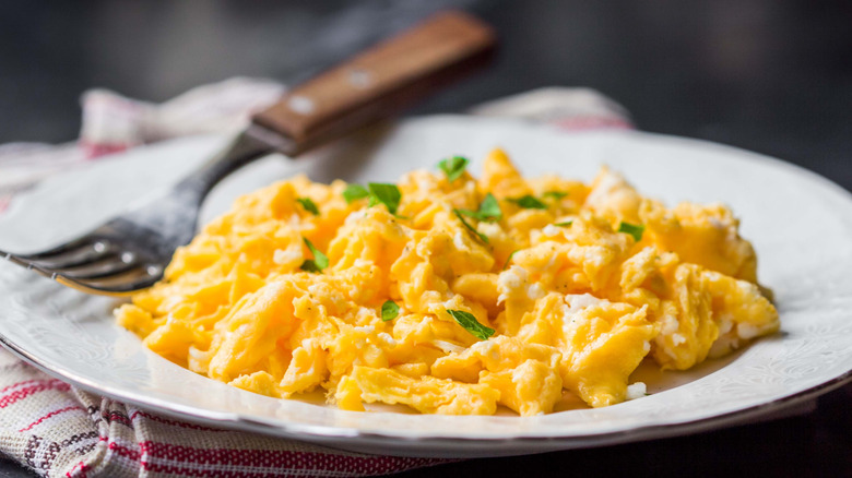 Plate of scrambled eggs with herbs