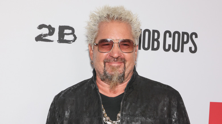 Close up of Guy Fieri with a cigar in his mouth