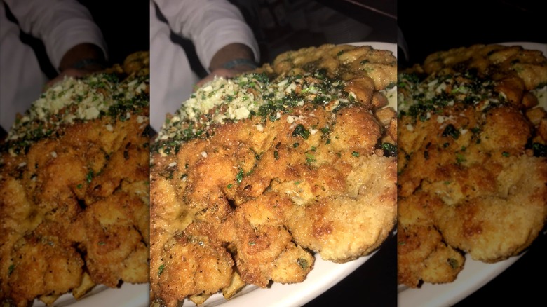 A close-up of the breaded veal chop a la gabe with a perfectly brown, crispy exterior.