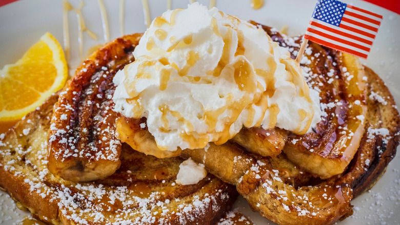 close up of bananas foster on French toast with whipped cream